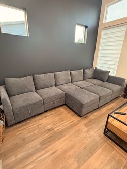 Large gray 8 piece modular sofa with storage