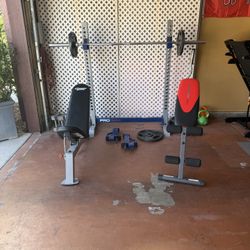 Benches (2)  4-45’s, 2-35’s, Curl bar, 7ft Bench Bar, 2-10’s, 2-15s, 2-25s, 2-25s And Bench Press Rack