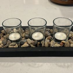 Decorative candles with pebble rocks and platform