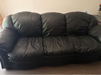 Black leather couch and black glass table