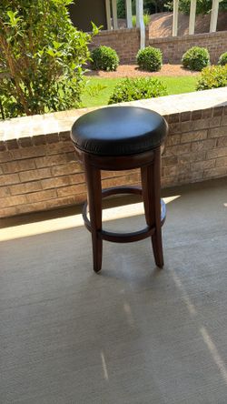 Beautiful walnut barstools with black leather cushion covered seats