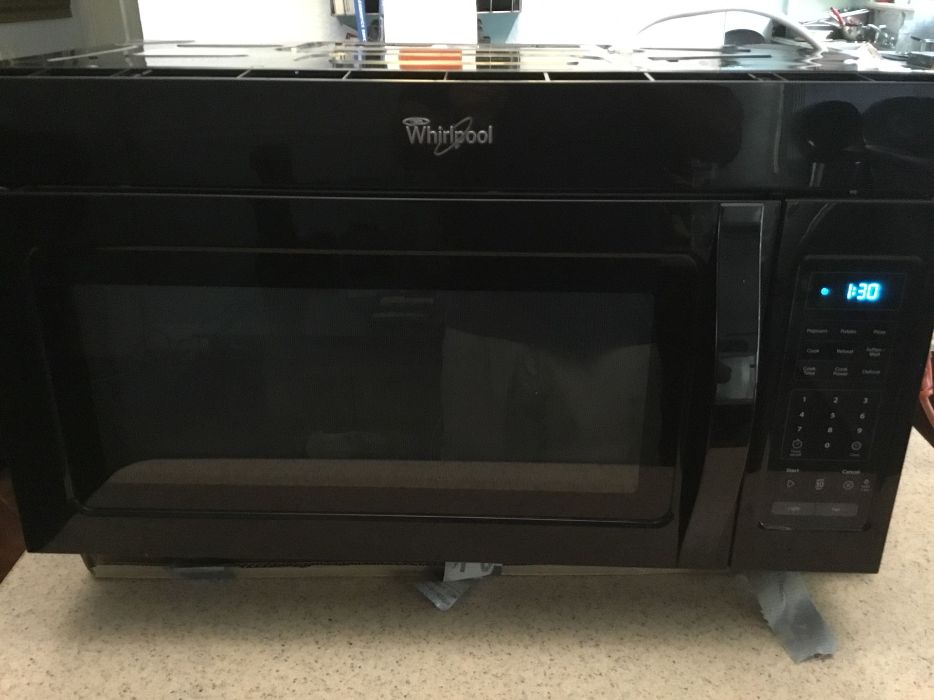 World pool cabinet mounted over the range microwave