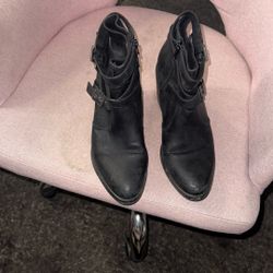 black leather ankle boots with buckle and zipper details.