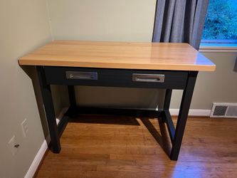 Desk with metallic pull out drawer