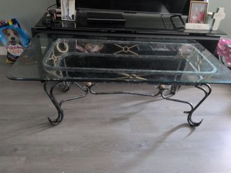 Iron glass coffee table / only needs the plastic round things to go inside for glass it's removable glass