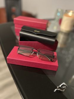 l:I Cartier black frame sunglasses with grey lens 