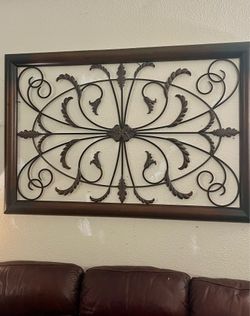 Decorative metal wall art features a scrollwork design w a distressed bronze finish! Consists of ornate scrollwork & leaf details framed in a rectangu