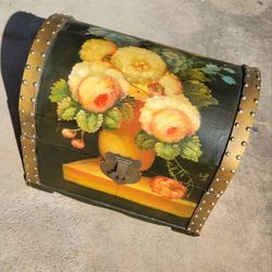 Vintage cottage-style floral dome-top trunk made of wood and metal. 
11" D × 14" H × 17" W