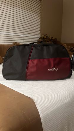 Brand new  15- inch duffle bag with 2-wheel for sport ,gym,traveling multipurpose used -black and cherry color