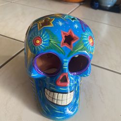Day of the dead skull, bookshelf, suitcases