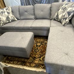New Grey Sectional. With Free Ottoman Sells For $899 