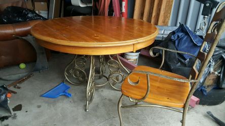 Wood and metal table with leaf and four chairs, two captain and two regular.