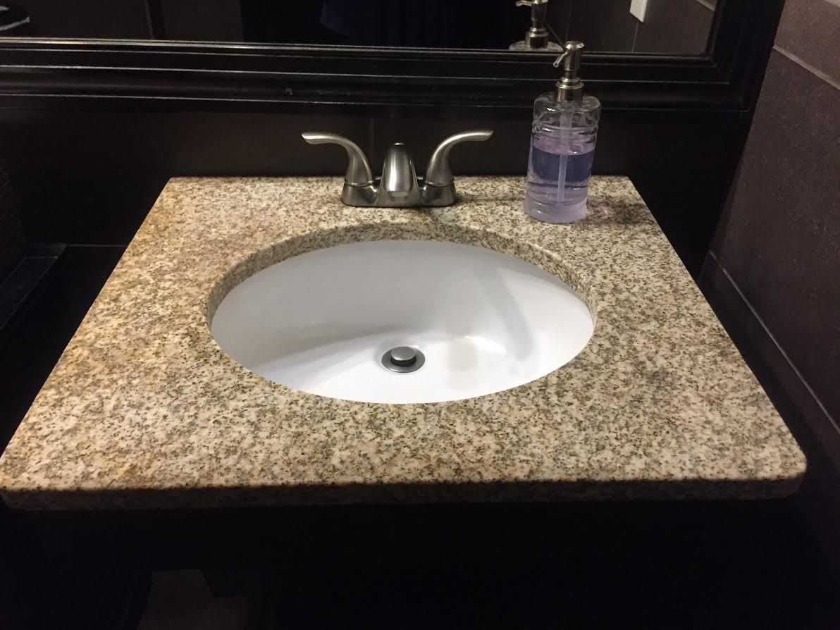 Bathroom vanity with marble top, sink and fixture