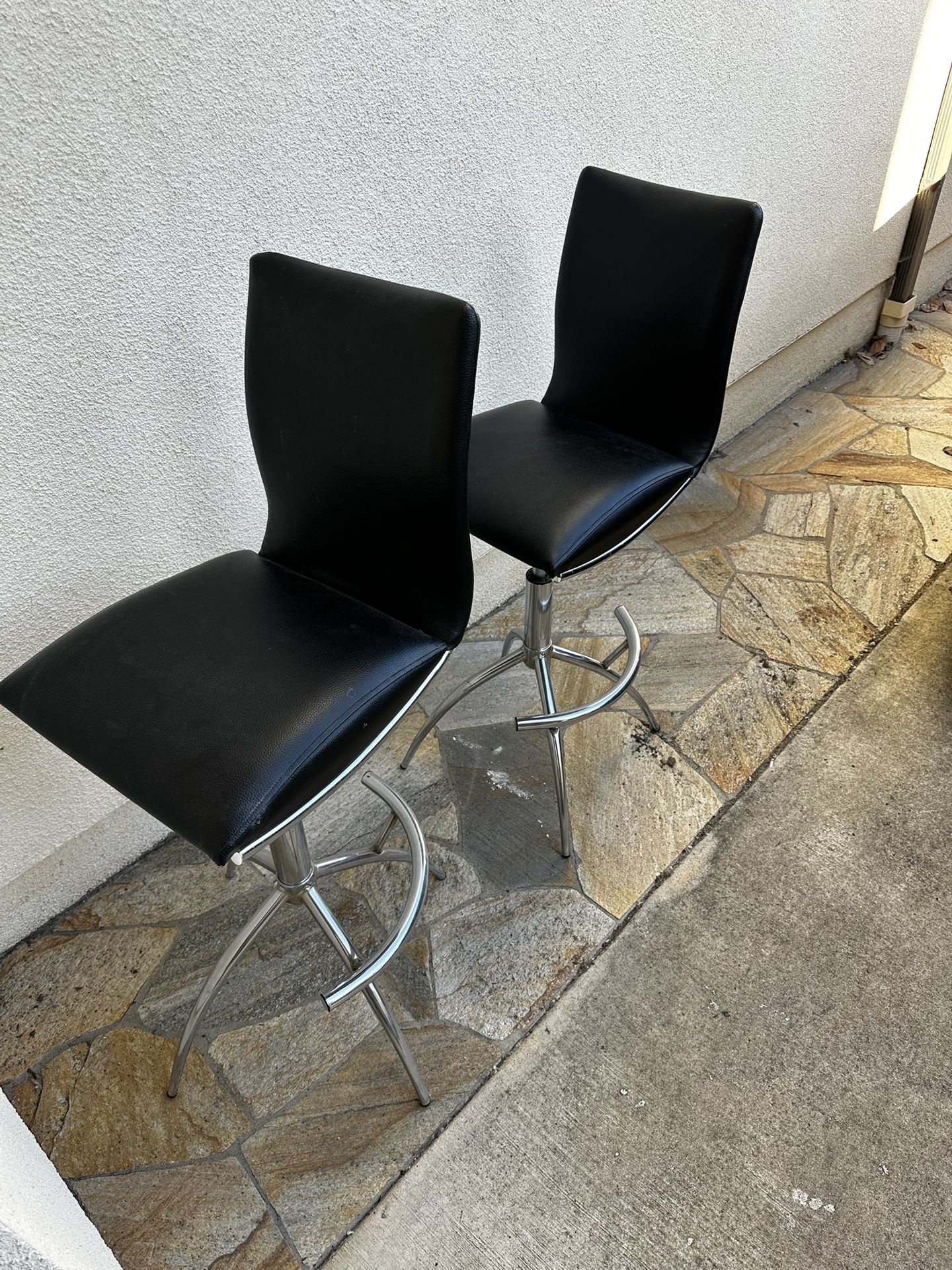 A Pair Of Black Leather Bar Stool