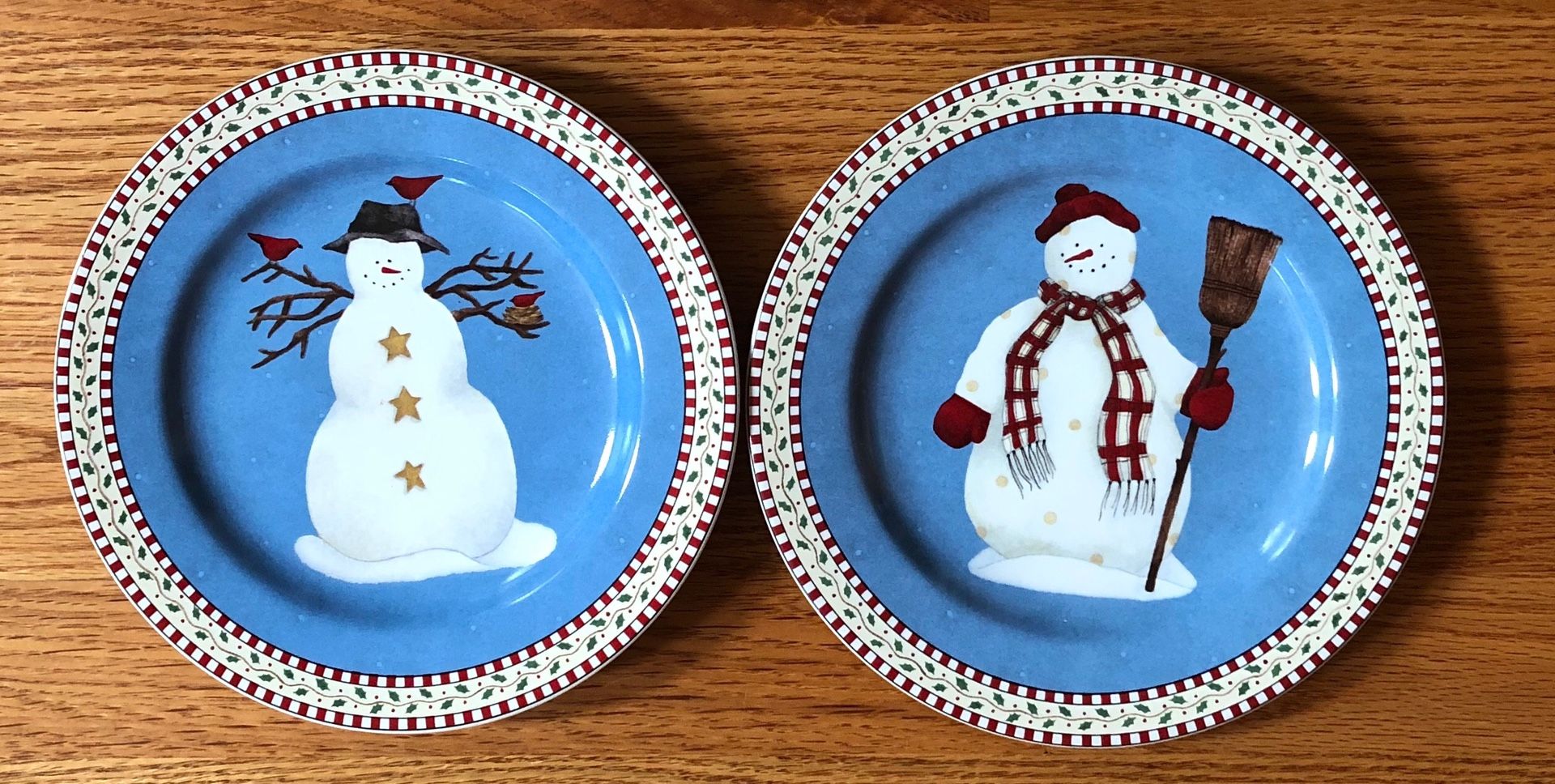 2 Sakura Snowman Plates by Debbie Mumm. Genuine Stoneware Indonesia. Dishwasher and Microwave Safe. About 7 inch diameter.