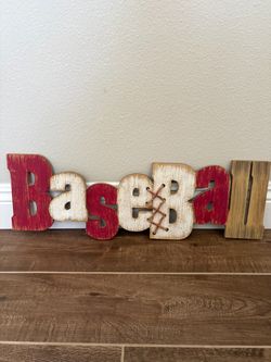 rustic wooden "Baseball" wall art sign featuring distressed red and white letters with faux baseball stitching on the letter