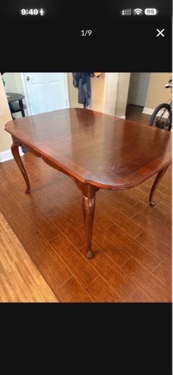 Dining table with protective cover and extra leaf