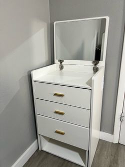 White vanity with cuahioned seat