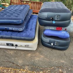 Many Different Air Mattress Some With Built In Pump Some Without. Blown Up To Show They Work