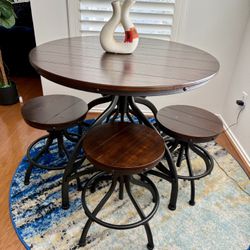 Table and stools From the "Odium" or "Valebeck" collection, which are manufactured by Ashley Furniture.
