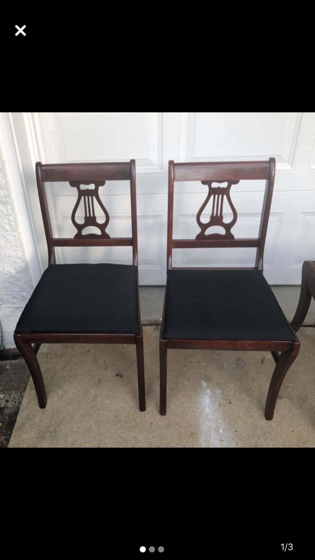 Two black and wooden antique chairs