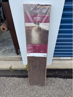 Home Decorators Collection 12mm glueless laminate flooring product in the Dark Hickory color
