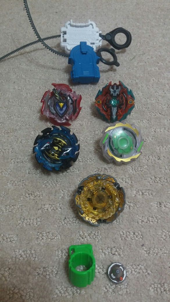 5 beyblades and two launchers