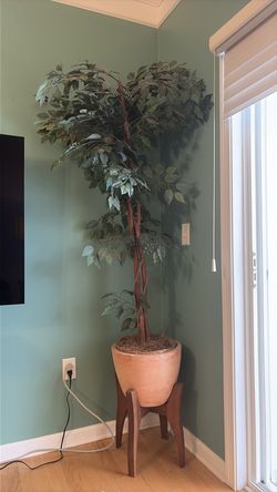 faux ficus tree with beautiful clay nase and wooden stand