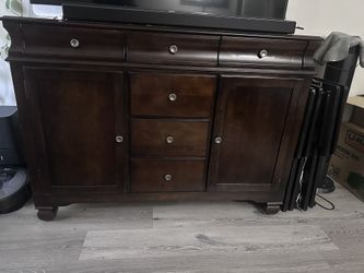 rich walnut-finished or server cabinet that can be used as a buffet or an entertainment center