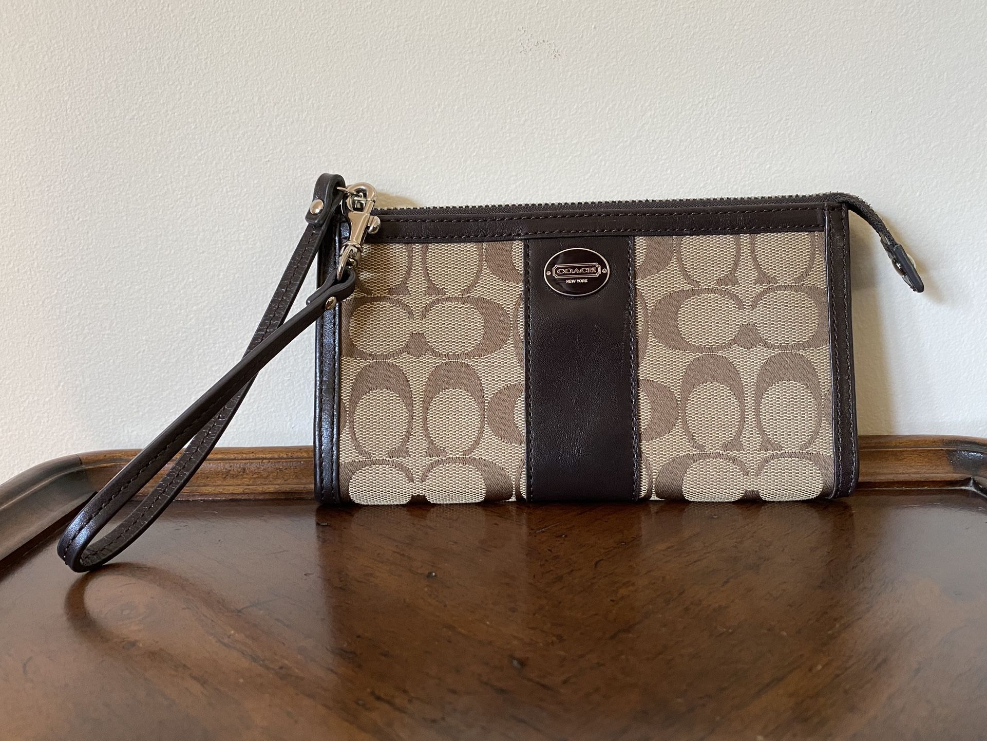 COACH brown and taupe convertible wristlet / wallet with signature “C” pattern and leather accents - GOOD CONDITION