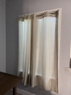 Beige curtains and curtain rods