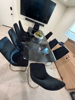 Beautiful black glass and metal dining table and 10 chairs