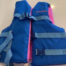 Assortment Of Life Vests For Boating Or Water Sports 