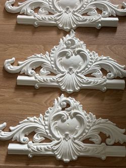decorative white wall moldings with a classic ornate design. They have a durable composition finish. Each piece is approximately (11.8" by 20