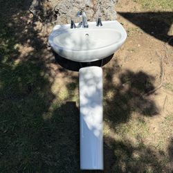 Pedestal sink with top faucet