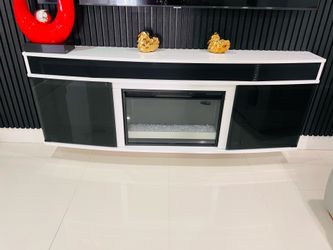 Under TV console with the built-in electric fireplace, + Bluetooth Speaker modern and in very good condition.