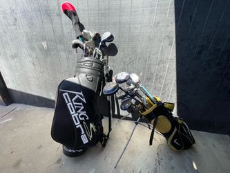 Two golf bags and 31 various golf clubs
