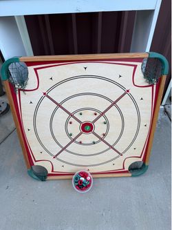 Carom board game  double sided. Has pieces ( not sure if complete or not ) no cues .