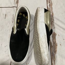 VANS SHAKE JUNT SLIP-ON BLACK AND GOLD LOW TOP SKATE SHOES