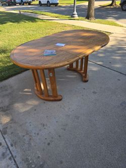 Wooden Table, no chairs... has extra leaf.