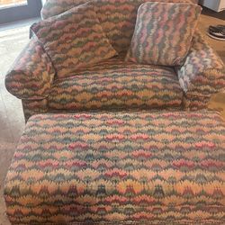 oversized armchair and matching ottoman feature a classic flame stitch