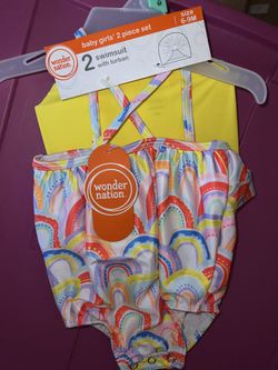New. 6/9mos swimsuit and cap set