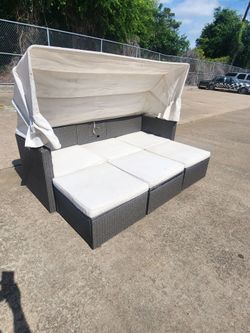 Turn your backyard into a private resort with this beautiful all-weather wicker patio daybed lounge set. This versatile outdoor set easily converts fr