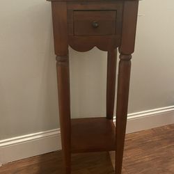 Vintage-style wooden accent table with drawer and lower shelf
