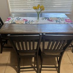 Ashley Furniture dining table with wine rack.