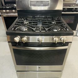 GE stainless steel natural gas stove with a receipt for a 60-day warranty