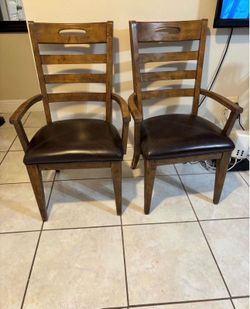 Pair of solid wood arm chairs