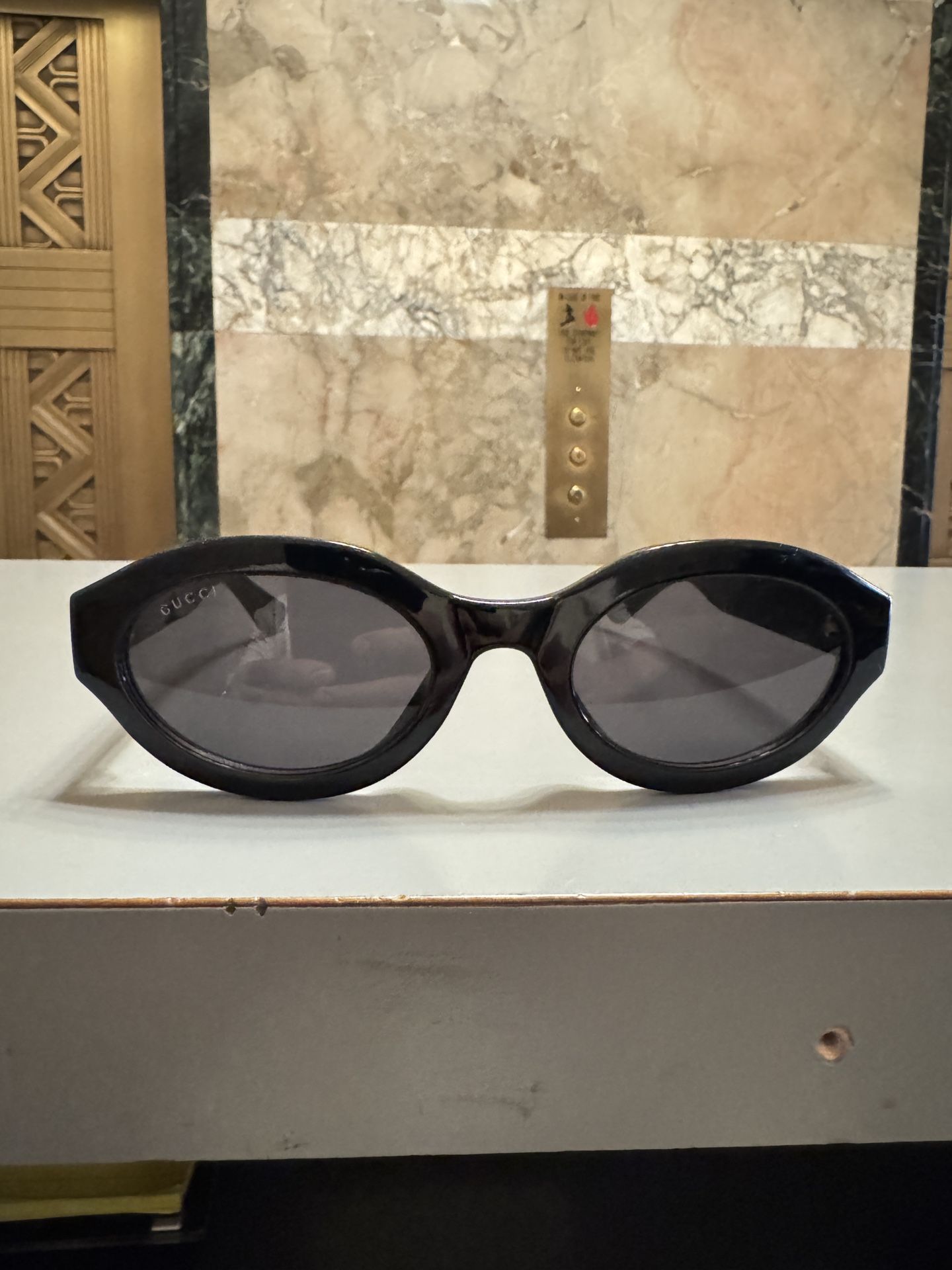 Gucci Oval Shiny Black and Gold Sunglasses