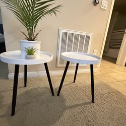 Pair of white round side tables with black legs