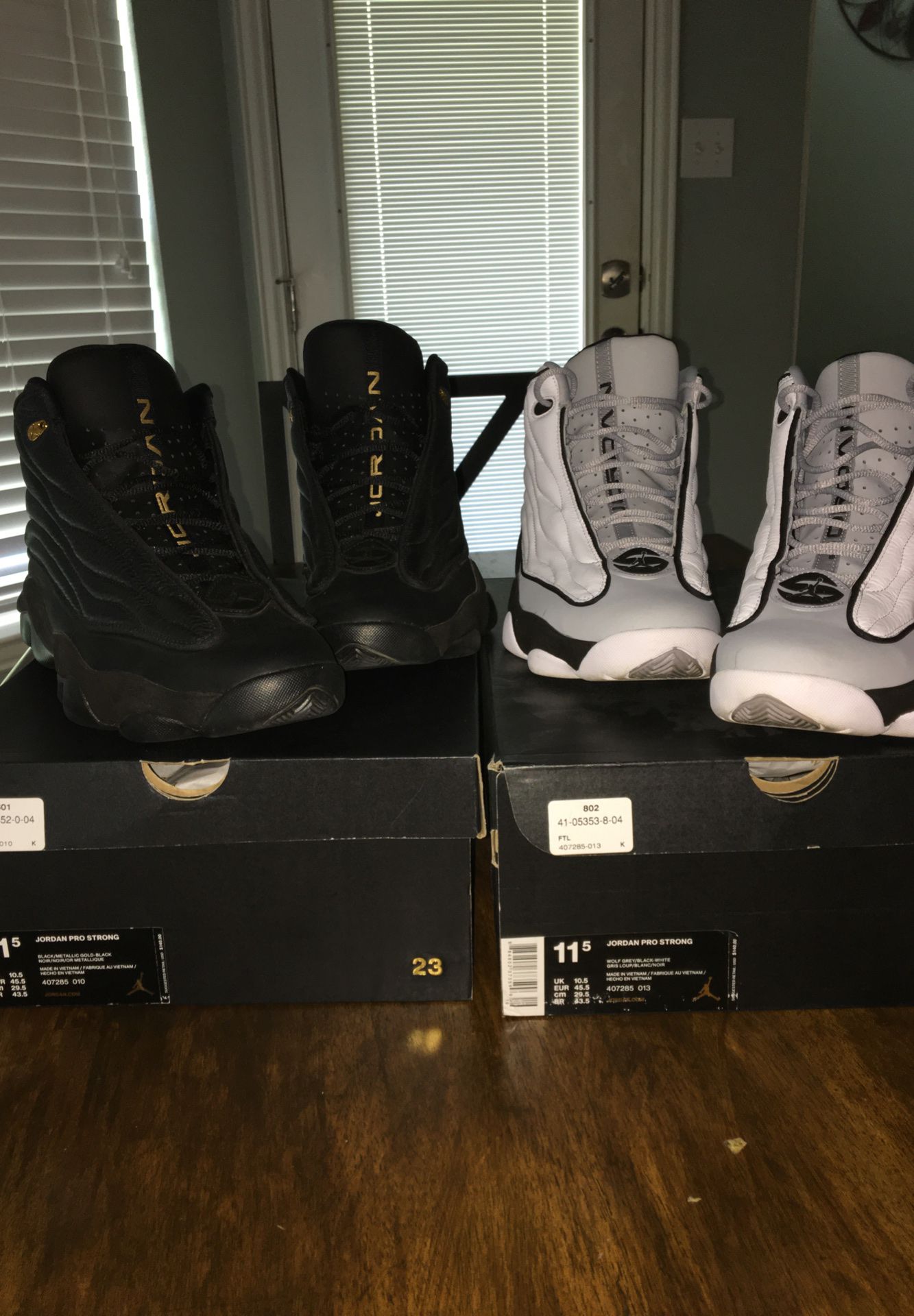 2 pairs of Jordan. 1 all black pro strong size 11.5, 1 white,grey,black 11.5